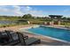 Relaxing poolside view with lounge chairs, pergola, and golf course backdrop for the perfect summer day at 19802 E 54Th Ave, Denver, CO 80249