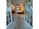 Main bedroom with access from hallway and double doors at 4375 Tongue Rd, Indian Hills, CO 80454