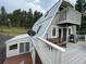 Spacious deck with mountain views, grill, and seating area at 4375 Tongue Rd, Indian Hills, CO 80454