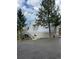 A-frame home with metal roof, deck, and paved driveway, nestled among trees at 4375 Tongue Rd, Indian Hills, CO 80454