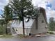 A-frame home with metal roof, deck, and mature trees in the yard at 4375 Tongue Rd, Indian Hills, CO 80454