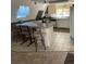 Kitchen with island, white cabinets, and speckled countertops at 4375 Tongue Rd, Indian Hills, CO 80454