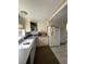 Galley kitchen with white cabinets and speckled countertops at 4375 Tongue Rd, Indian Hills, CO 80454