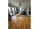Living room with hardwood floors, a comfy chair, and access to deck at 4375 Tongue Rd, Indian Hills, CO 80454