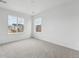 Bright bedroom featuring neutral carpet and a large window providing neighborhood views at 25303 E Warren Pl, Aurora, CO 80018
