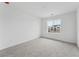 Bright bedroom featuring neutral carpet and a large window providing neighborhood views at 25303 E Warren Pl, Aurora, CO 80018