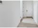 Bright hallway features wood-style flooring and white walls, offering a clean aesthetic at 25303 E Warren Pl, Aurora, CO 80018