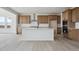 Open kitchen with a large center island, modern appliances, and light wood cabinetry at 25303 E Warren Pl, Aurora, CO 80018