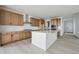 Spacious kitchen featuring a center island, wood cabinetry, and modern appliances at 25303 E Warren Pl, Aurora, CO 80018