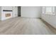 Spacious living room featuring light wood floors and natural light at 25303 E Warren Pl, Aurora, CO 80018