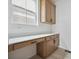 Home office with custom built-in desk area, wood cabinets, and natural lighting at 25303 E Warren Pl, Aurora, CO 80018