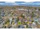 A picturesque aerial view highlighting the property's position in a residential area with mature trees and city backdrop at 4916 Knox Ct, Denver, CO 80221