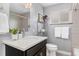 Stylish bathroom with modern vanity, white countertops, and tiled shower at 4916 Knox Ct, Denver, CO 80221