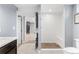 Bathroom featuring a tiled walk-in shower with a built-in seat, accompanied by neutral decor at 4916 Knox Ct, Denver, CO 80221
