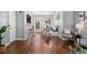 Bright dining area with a breakfast bar, modern table with a built-in bench, and hardwood floors at 4916 Knox Ct, Denver, CO 80221