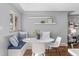 Bright dining nook with built in benches, a round white table, hardwood floors, and natural light at 4916 Knox Ct, Denver, CO 80221