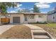 Charming single-story brick home with a well-maintained lawn, a walkway, and a one car garage at 4916 Knox Ct, Denver, CO 80221