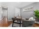 Home office featuring a desk, gray accent chair, and a large potted plant at 4916 Knox Ct, Denver, CO 80221