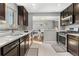 Open kitchen featuring stainless steel appliances, breakfast nook, and wood flooring at 4916 Knox Ct, Denver, CO 80221