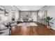 Bright living room with hardwood floors, large windows, a modern sofa, and neutral décor at 4916 Knox Ct, Denver, CO 80221