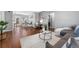 Cozy living room with hardwood floors, neutral tones, modern furniture, and an adjacent dining area at 4916 Knox Ct, Denver, CO 80221