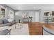 Comfortable living room featuring hardwood floors, a gray sofa, and an open layout to the kitchen at 4916 Knox Ct, Denver, CO 80221