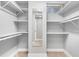 Walk-in closet with ample shelving, a full-length mirror, and bright lighting at 4916 Knox Ct, Denver, CO 80221