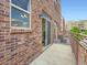 Brick balcony with a metal railing and sliding glass door entry at 5467 Zephyr Ct # 5467, Arvada, CO 80002
