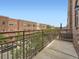 Balcony with metal railings overlooks a street view of townhouses at 5467 Zephyr Ct # 5467, Arvada, CO 80002