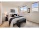 Bright bedroom with a large window, bench and stylish decor at 5467 Zephyr Ct # 5467, Arvada, CO 80002