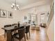 Open-concept dining area with a black dining table, connecting to a well-lit living room and kitchen at 5467 Zephyr Ct # 5467, Arvada, CO 80002