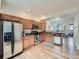 Open-concept kitchen with wood cabinets, modern appliances, and hardwood flooring throughout at 5467 Zephyr Ct # 5467, Arvada, CO 80002