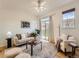 Bright living room with a sliding glass door to a balcony, a ceiling fan, and neutral decor at 5467 Zephyr Ct # 5467, Arvada, CO 80002