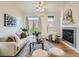 A well-lit living room with a fireplace, sliding glass door to the balcony, and comfortable seating at 5467 Zephyr Ct # 5467, Arvada, CO 80002