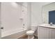 Bright bathroom featuring a sleek vanity, toilet, and a tiled shower-over-tub combo with modern fixtures at 15286 Fillmore St, Thornton, CO 80602