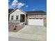 Charming single Gathering house with brick and siding details and an attached two car garage at 15286 Fillmore St, Thornton, CO 80602