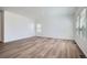 Spacious living room featuring hardwood floors and natural light from the bright windows at 15286 Fillmore St, Thornton, CO 80602