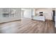 Bright open-concept living room and kitchen area with hardwood floors and large windows at 15286 Fillmore St, Thornton, CO 80602