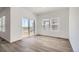Bright living room with wood floors and sliding glass door to backyard at 15286 Fillmore St, Thornton, CO 80602