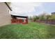 Spacious backyard featuring a large green lawn and a charming deck perfect for outdoor entertaining at 6141 S Estes St, Littleton, CO 80123