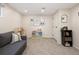 Finished basement with neutral decor including a sofa, play area, and storage space at 6141 S Estes St, Littleton, CO 80123