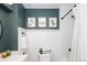 Stylish bathroom with wainscoting, white vanity, and tiled shower with black fixtures at 6141 S Estes St, Littleton, CO 80123