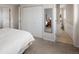 Bright bedroom featuring carpet floors, a large closet, and an ensuite bathroom at 6141 S Estes St, Littleton, CO 80123