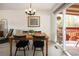 Cozy dining room with a wooden table, black chairs, and sliding glass door to the backyard at 6141 S Estes St, Littleton, CO 80123