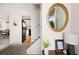 Bright foyer featuring modern decor, a decorative mirror, and views of the living spaces at 6141 S Estes St, Littleton, CO 80123