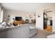 Spacious living area featuring a comfortable sectional and open access to the dining area at 6141 S Estes St, Littleton, CO 80123