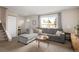 Comfortable living room with stylish gray sectional sofa and large window at 6141 S Estes St, Littleton, CO 80123