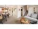 Open concept living room and dining area with stairs and neutral decor at 6141 S Estes St, Littleton, CO 80123