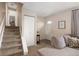 Inviting living room with a staircase, front door, and cozy seating area at 6141 S Estes St, Littleton, CO 80123