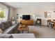 Cozy living room with modern furniture and a large window offering natural light at 6141 S Estes St, Littleton, CO 80123